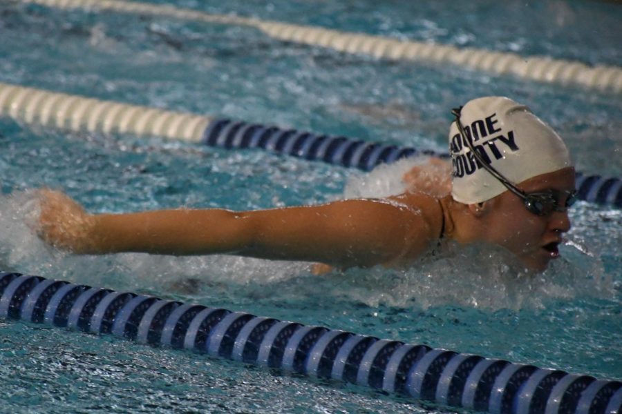 Freshman Sydney Whitford swims butterfly.