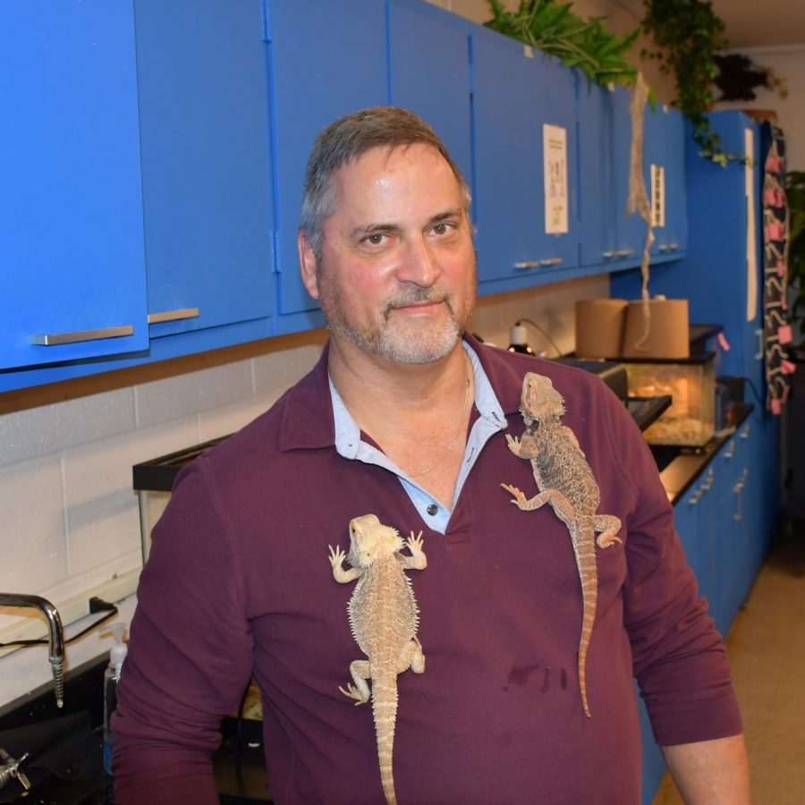 Science teacher Ray Kues allows his bearded dragons to cling to his shirt. 