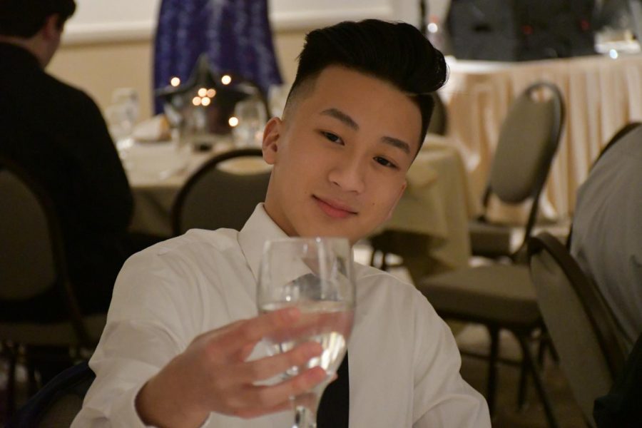 Senior Kevin Le holds his glass up for a toast at the Senior Dinner Dance on 1/26/19