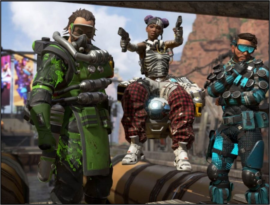 Apex+Legends+characters+%28LEFT+TO+RIGHT%29%3A+Caustic%2C+Lifeline%2C+and+Mirage+wearing+unlockable+clothing+in+the+Kings+Canyon+arena.