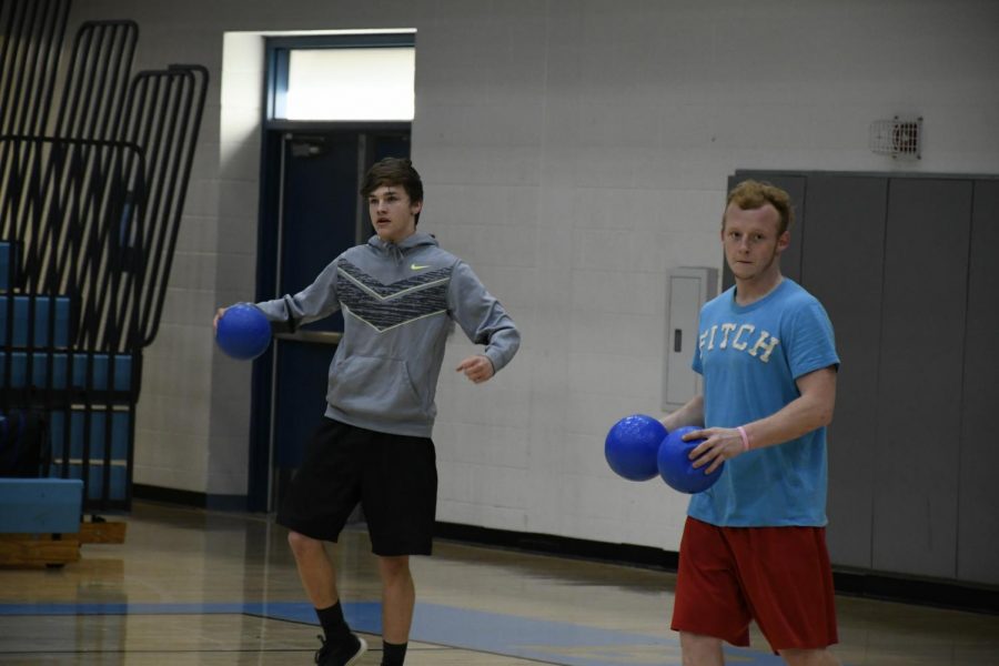 Seniors Trevor Miller (LEFT) and Hunter Freeman compete in the National Honor Society’s annual dodgeball tournament in the Boone gym on March 22. The event raised money for the organization.