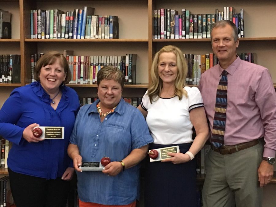 (Left to right) Retirees Patty Mueller, Louanna Wyatt, and Diane Talbert stand with principal Tim Schlotman during the annual retirees reception on May 9 in the Boone library.