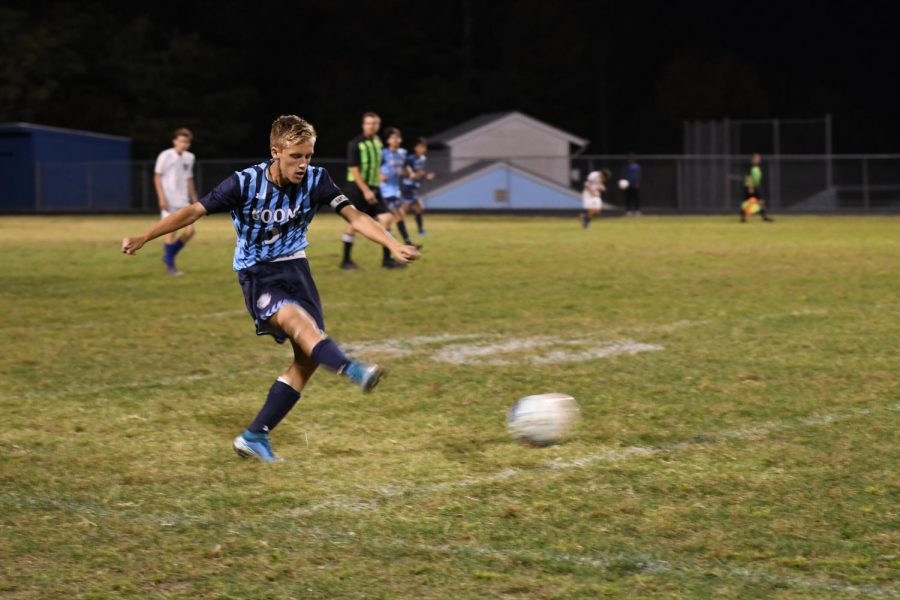 Brendan Hughes kicks the ball across the field, during the soccer game at Boone County high school on Oct. 3. 