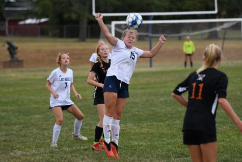 Junior Maddy Hobbs jumps up and hits the ball with her head, during the district soccer game at Conner high school on Oct. 6. 