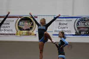 Senior Ali Schuster and sophomore Payeton Wright cheer from atop the build at the KHSAA Region 5 Championship at Boone County High School on Nov. 23.
