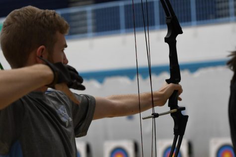 Junior Luke Smalley shoots a bow and arrow at the archery tournament at Boone County High School on Jan. 11. 