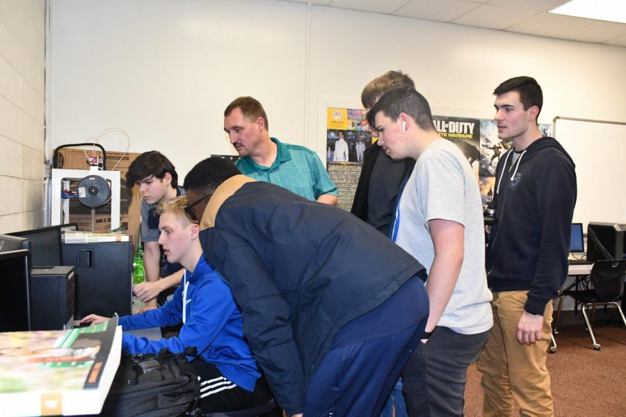 The Esports team gathers around to support Senior Brendon Hughes during the first ever esports match on Feb. 20 in room 220.