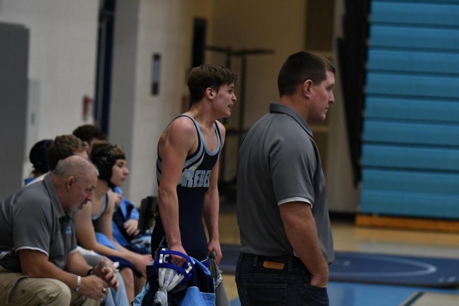 Senior CeJay Vaske yells encouragement while assistant coach Chip McCord looks on during a match at the county championship at Boone on Jan. 15.