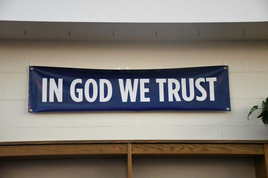 The national motto, “In God We Trust,” is displayed on a banner in the school library  to comply with House Bill 46, which became a law last year with the support of every Boone County politician.