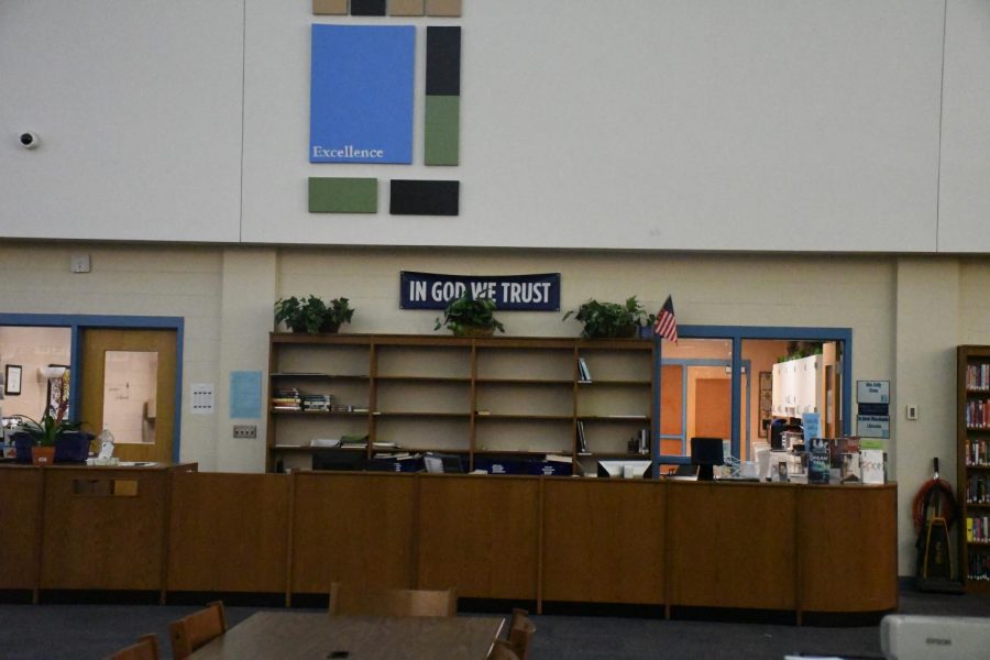 The national motto, “In God We Trust,” is displayed on a banner in the school library  to comply with House Bill 46, which became a law last year with the support of every Boone County politician.