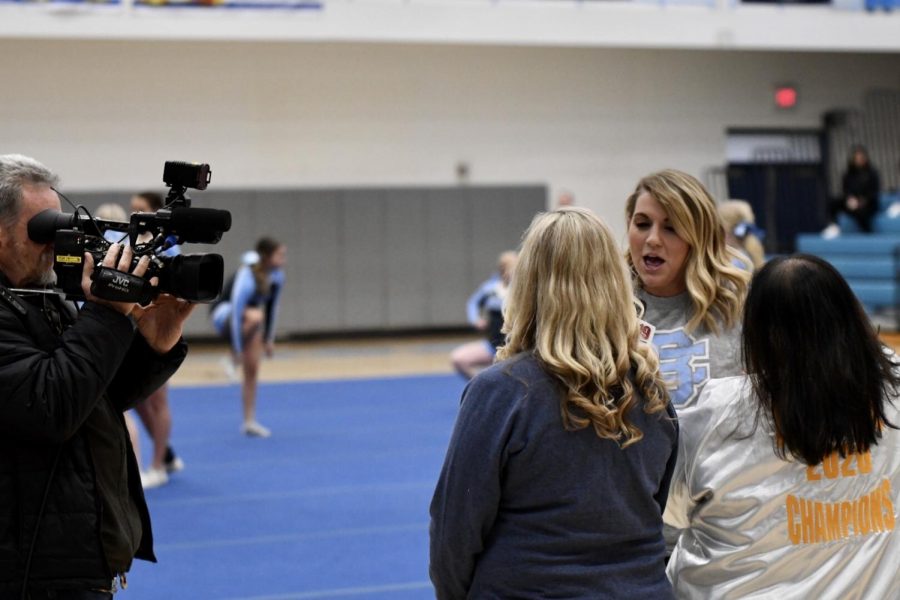 Fox19 reporter and Boone alumna Lauren Minor interviews cheer coaches Michelle Schuster (left) and Kim Grimes (right) during the winter pep rally on Feb. 14.