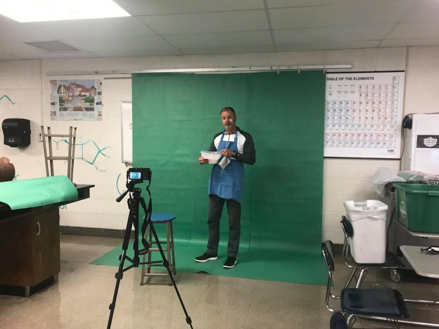 Principal Tim Schlotman is recorded in front of a green screen in room 227 for the Principals Report video that was published on Nov. 20.