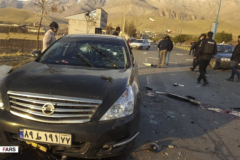 Officials move about the scene of Iranian scientist's vehicle after he was shot outside of his car in Tehran, Iran on Friday, Nov. 27.