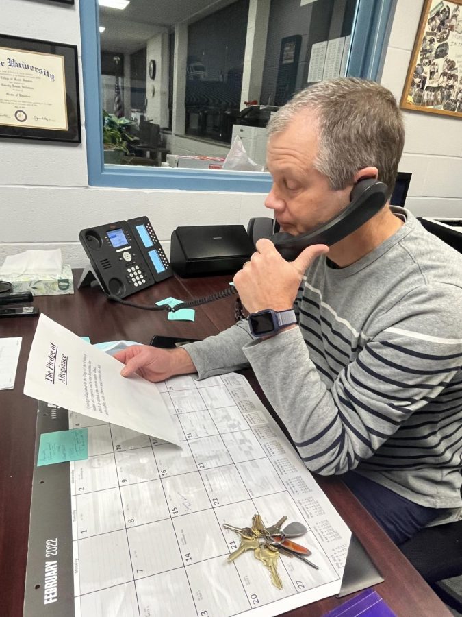 After using the new bell system to signal the school, principal Timothy Schlotman reads the Pledge of Allegiance during the morning announcements on Feb. 17.