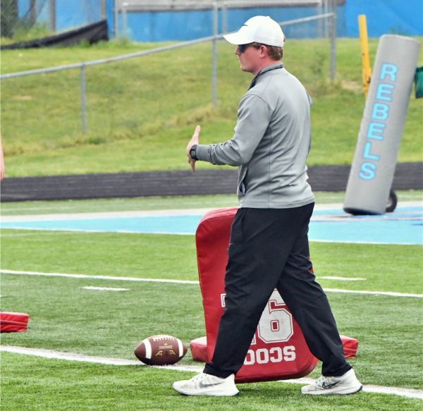 Football coach Daniel Court provides instruction between reps during spring practice on May 3.