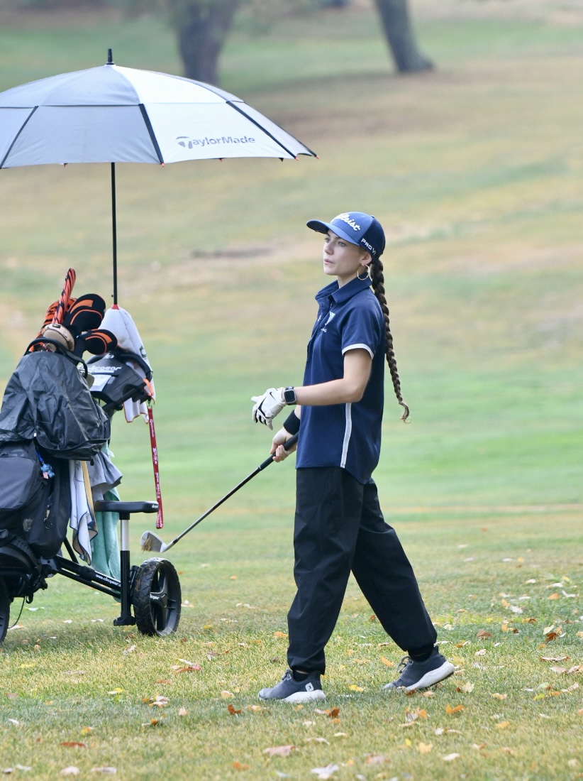 Sophomore Jayden Ramler watches her shot at the Region 7 girls golf championship at Kenton County on Sept. 24.