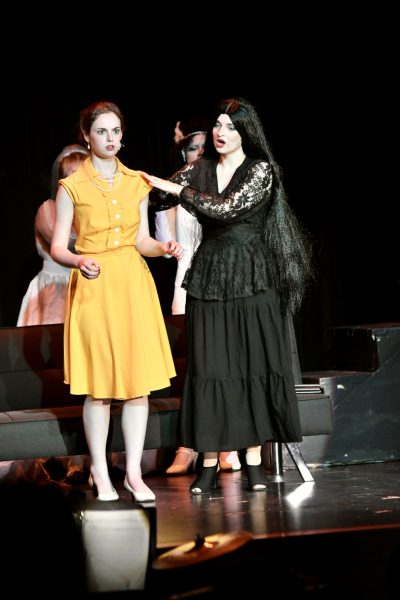 Alice (left by junior Samantha Kolks) and Morticia (played by junior Elena Gartner) share a musical number during the performance of "The Addams Family" on May 11 at Boone County High School.