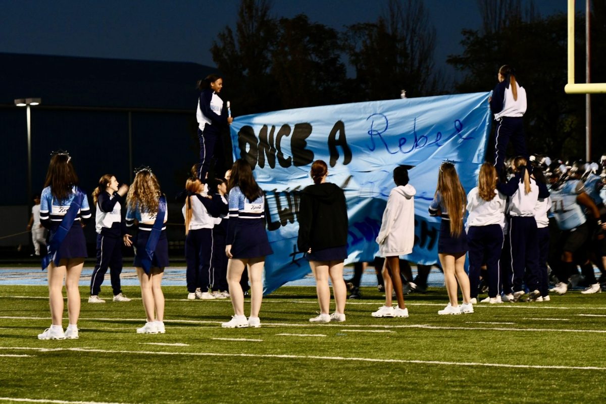 The cheer, dance, and football teams prepare for the football team's run out before the game against Cooper on Nov. 1.