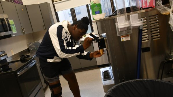 Sophomore Jayden Pointer uses the ice cream machine in room 101 on Nov. 21. Ice cream is being sold to benefit the Family, Career, and Community Leaders of America (FCCLA) and the Family Consumer Science (FCS) classes. 