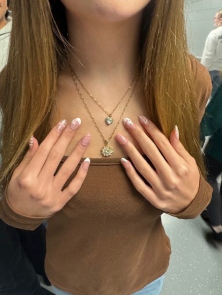 This photo depicts a Boone student who has very fashionable nails and jewelry on that makes her look accessorized and in season.